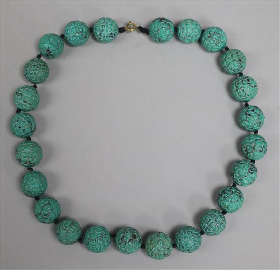 A carved turquoise bead necklace.